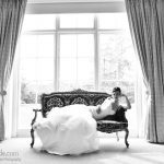 Bride laying on chaise in old hotel
